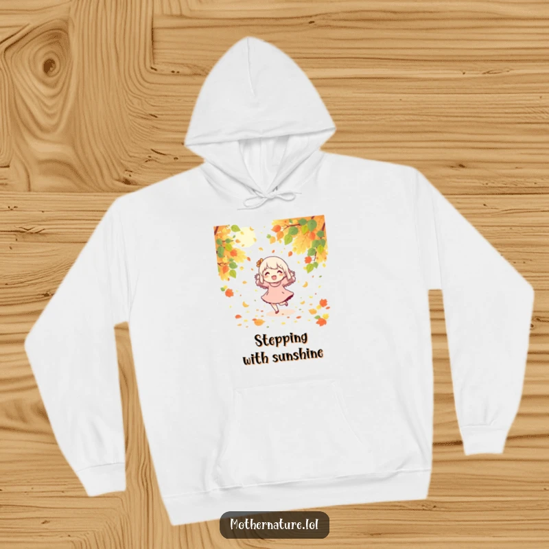 Funny hoodie featuring a character joyfully dancing amidst a cascade of falling leaves and sunshine.